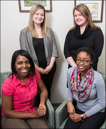 Working together to help new mothers and pregnant women manage their recovery through the PARC program are PARC coordinator Alicia Bell, standing at left, and ECU master's students Gwen Gilbert, seated left, Qu’Nesha Hinton, seated right, and Erin Swanson, standing right.