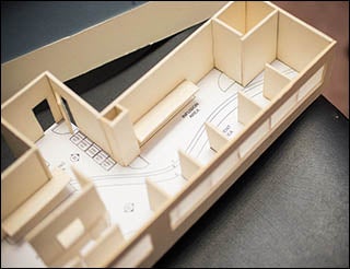 A model demonstrates the layout of the proposed treatment spaces at the center.