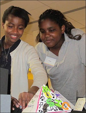 Destiny Dixion-Braswell and Jadaja Britton examine artwork on display at the Eye-to-Eye art show at Joyner Library on April 11. (Photos by Kathryn Kennedy)