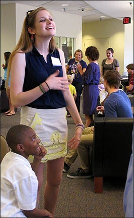 Emily Bosak, ECU sophomore and member of Project STEPP, and Marvion Wilcox, a student in the mentoring program, enjoy the art show.