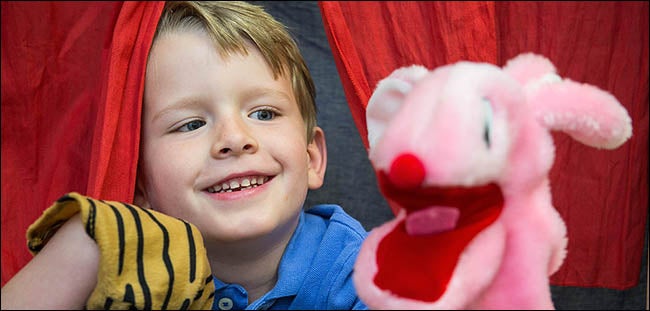 Christian uses puppets to demonstrate his improved communication skills. Activities at the autism center have helped Christian transition from being almost entirely nonverbal to being an outgoing conversationalist.