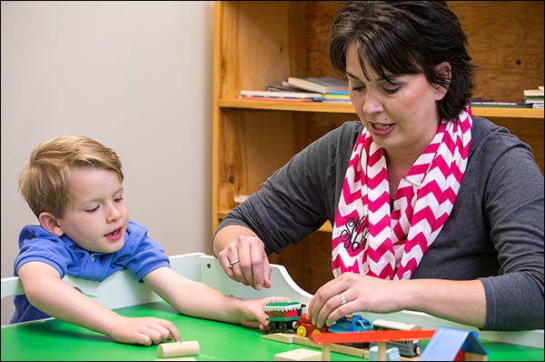 Sharon McLawhorn, right, and son Christian work together on a train set as part of Christian's activities at the center for patients with Autism Spectrum Disorder. McLawhorn said the Family Autism Center staff helped her see Christian's diagnosis as an opportunity rather than a "life sentence.