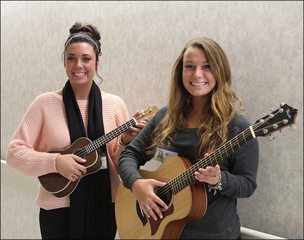 ECU music therapy students Amanda Bernstein and Emily Selitto help patients at Vidant Medical Center with music. (Contributed photo)