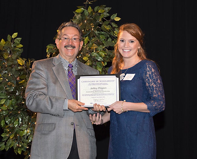 Dr. Leonard Trujillo, chair of the Department of Occupational Therapy, congratulates graduate student Ashley Thigpen on receiving the Jessica King Memorial Scholarship.