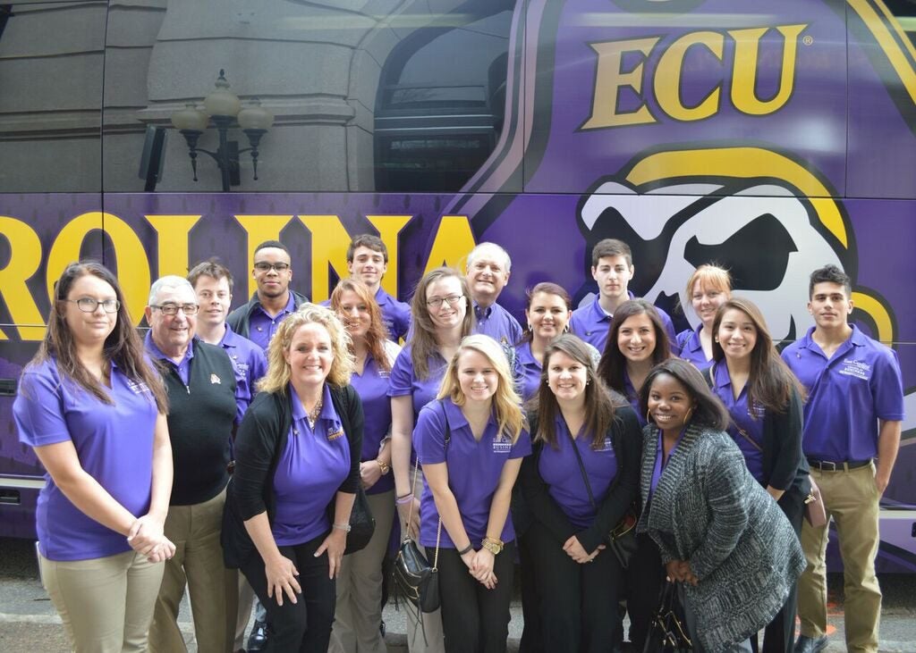 Posing before loading the bus for their trip to Atlanta, Georgia over ECU’s spring break are ECU risk management and insurance students, Pitt Community College students and ECU faculty members. (Contributed photo)