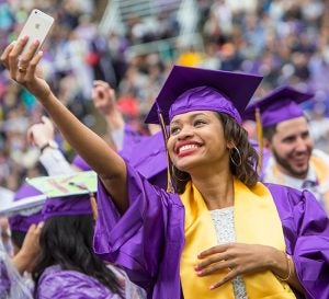 Graduates celebrate the time-honored turning of the tassels with excited “selfie” photos. (Photo by Cliff Hollis, ECU News Services)