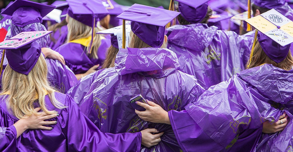 Umbrellas and ponchos were the order of the day, but the drizzle stopped as the ceremony began. (Photo by Cliff Hollis, ECU News Services)