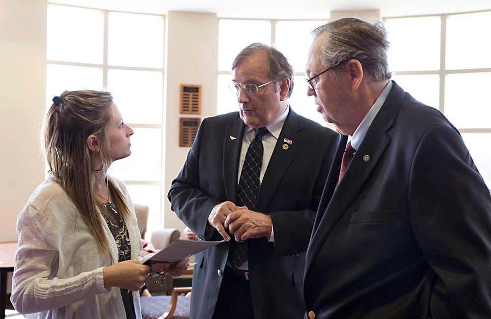 Speech-language pathology graduate student Kate DelGreco speaks with Scottish Rite masons Michael May and Tom Broderick about the pediatric programs they sponsor in ECU's Department of Communication Sciences and Disorders.