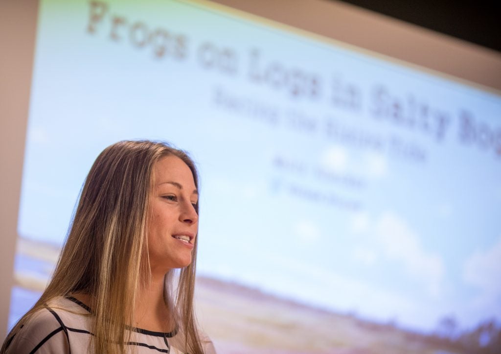 Graduate student Molly Albecker rhythmically talks about frogs on logs in salty bogs and racing the rising tide during the Three Minute Thesis competition on Oct. 26. 