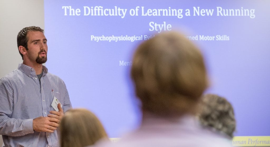 Graduate student Tyler Whittier presents on the difficulty of learning a new running style in ECU’s Mendenhall Student Center Great Rooms.