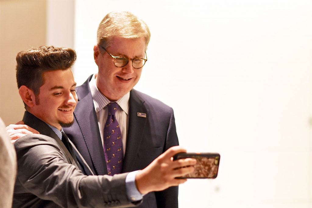 Chancellor Staton takes a selfie with a guest.