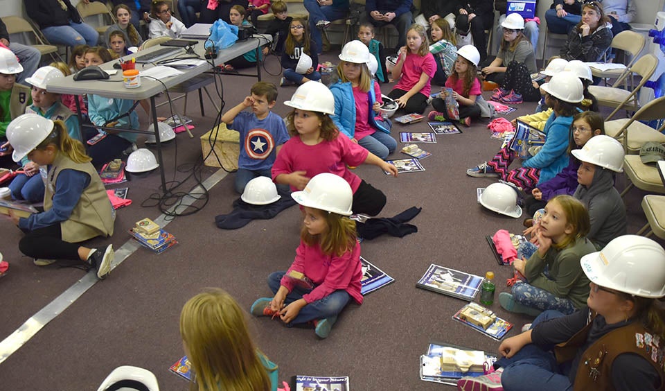 The Girl Scouts receive instructions before going out to the construction site. (Contributed photo)