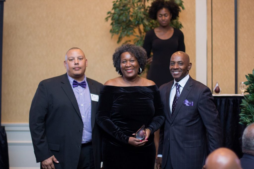 Sheridan Barnes, Black Alumni Chapter president, left, and Dr. Anthony Jackson, BAC president-elect, congratulate Linda Thompson Thomas on receiving the Laura Marie Leary Elliott Courageous Leader award.