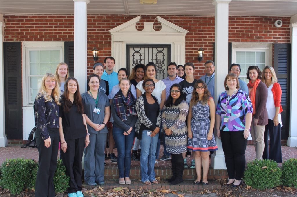 ECU master's and doctoral level students and faculty associated with the Greene Country Health Care Inc. Integrated Behavioral Health Care Project stand in front of ECU’s Redditt House.