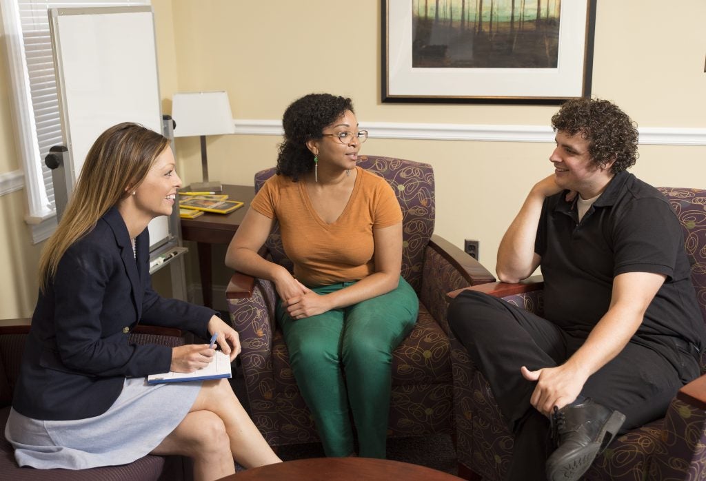 ECU students Jessica Goodman, Eunicia Jones and David Haralson discuss integrated behavioral health care and medical family therapy at the Redditt House.