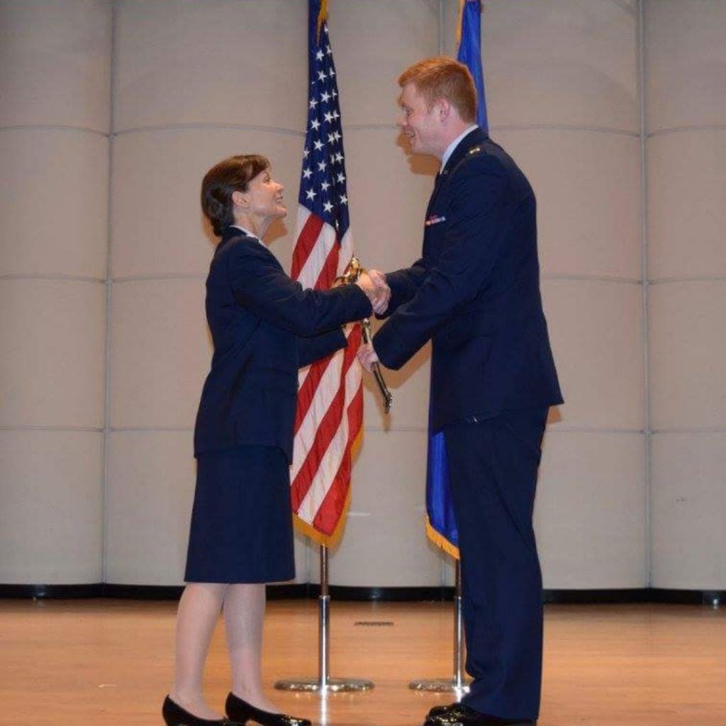 Jonathan Jeffries, right, receives a sabre in recognition of being named a Distinguished Graduate during his Air Force ROTC commissioning ceremony in December. (Contributed photo)