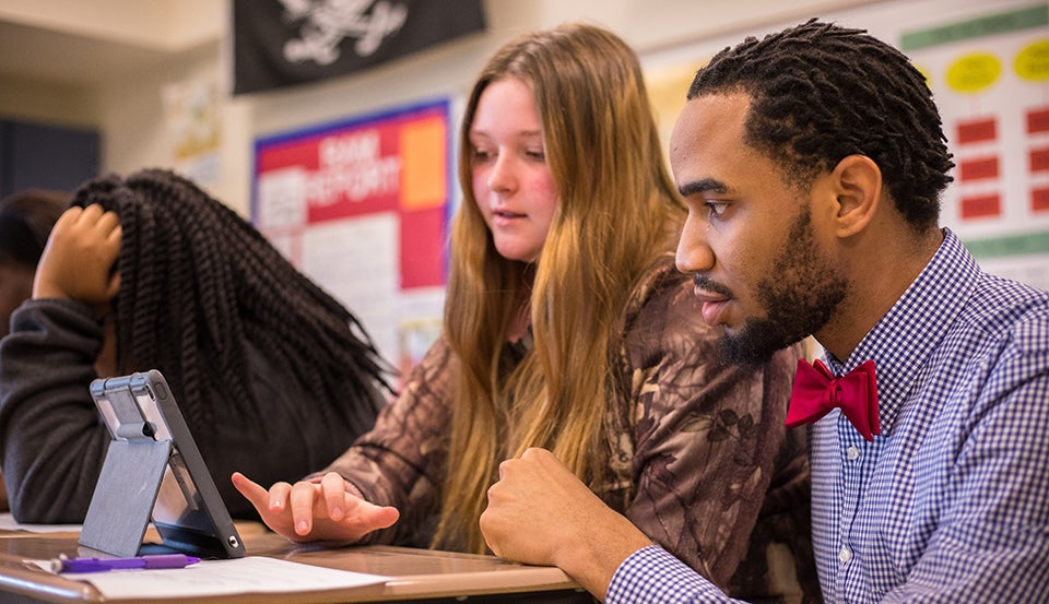 Charlie Howell III, assistant principal at Greene County Middle School and ECU alumnus, checks in on a history class.