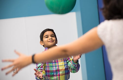 Daniel Ferrufino-Sosa tosses a ball with his mom, Claudia.