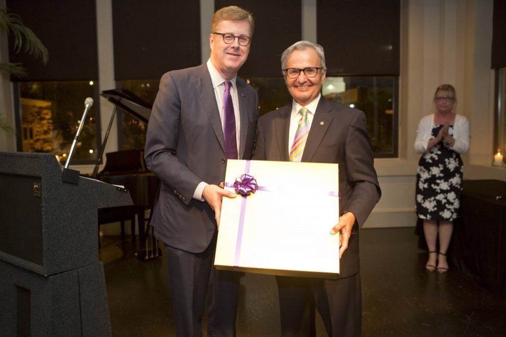 Outgoing UNC Board of Governors member Craig Souza (right) is recognized by Chancellor Staton for his service.