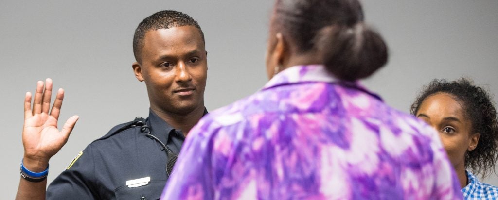 J. Bryant and his sister Latara Johnson listen to Vickie Joyner during the swearing in.