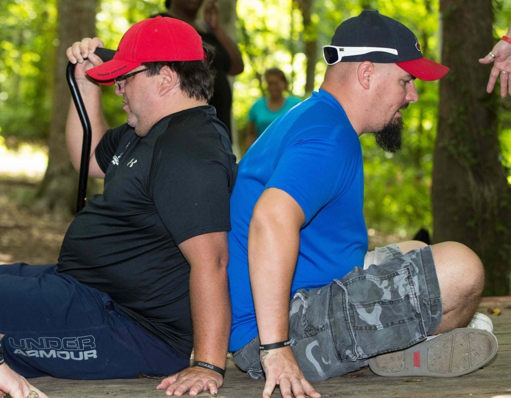 People balance on a wooden surface.