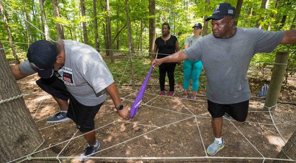 The group makes it way through a spider web in a cave while maintaining group contact.