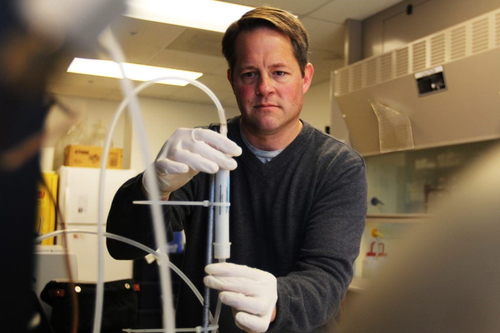 Dr. Michael Piehler prepares samples in the lab. 