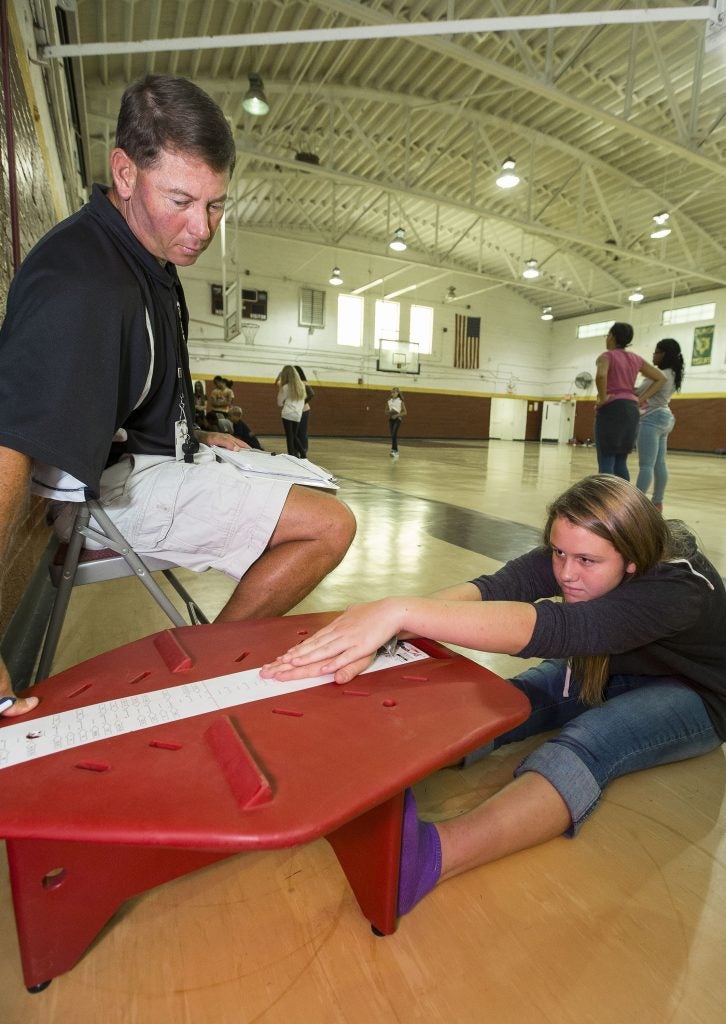 Physical education teacher Allen Harrell works with Krysta Styons in the MATCH Wellness program at Chowan Middle School in Tyner. (Photo by Cliff Hollis)