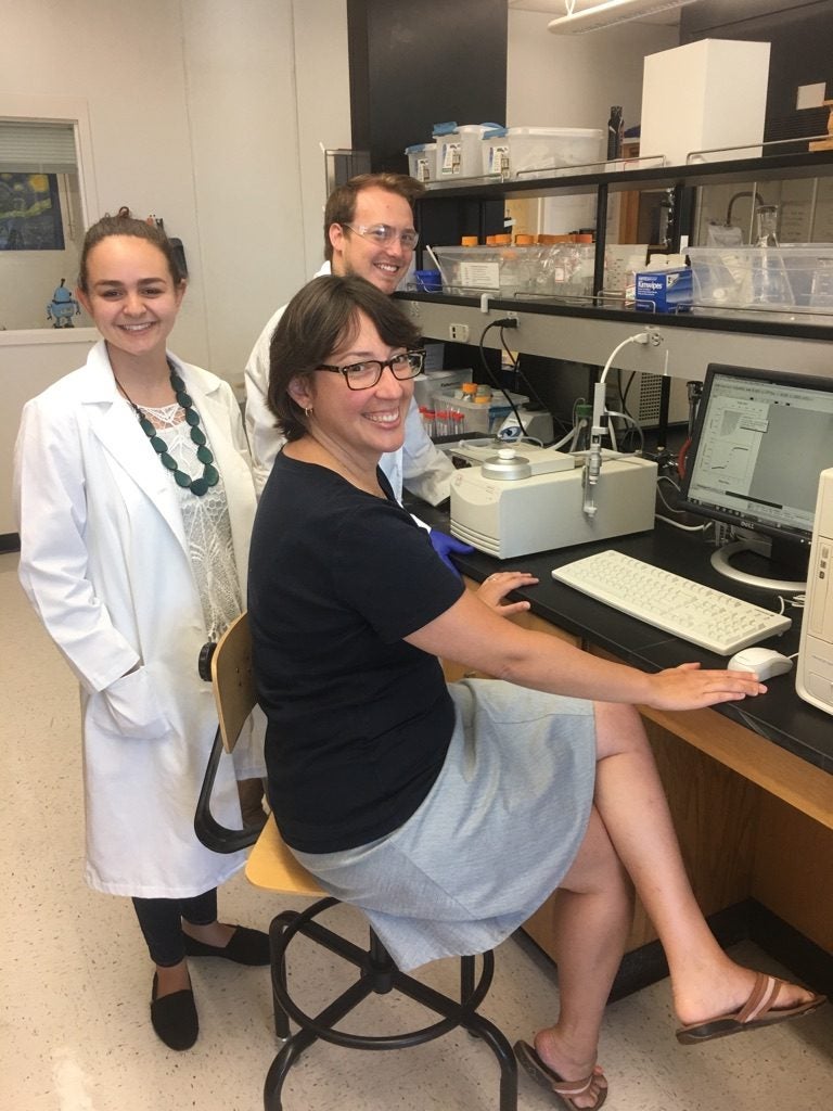 In the lab, from left to right: Caitlin Palmer, Jacob Montgomery, Dr. Anne Spuches.