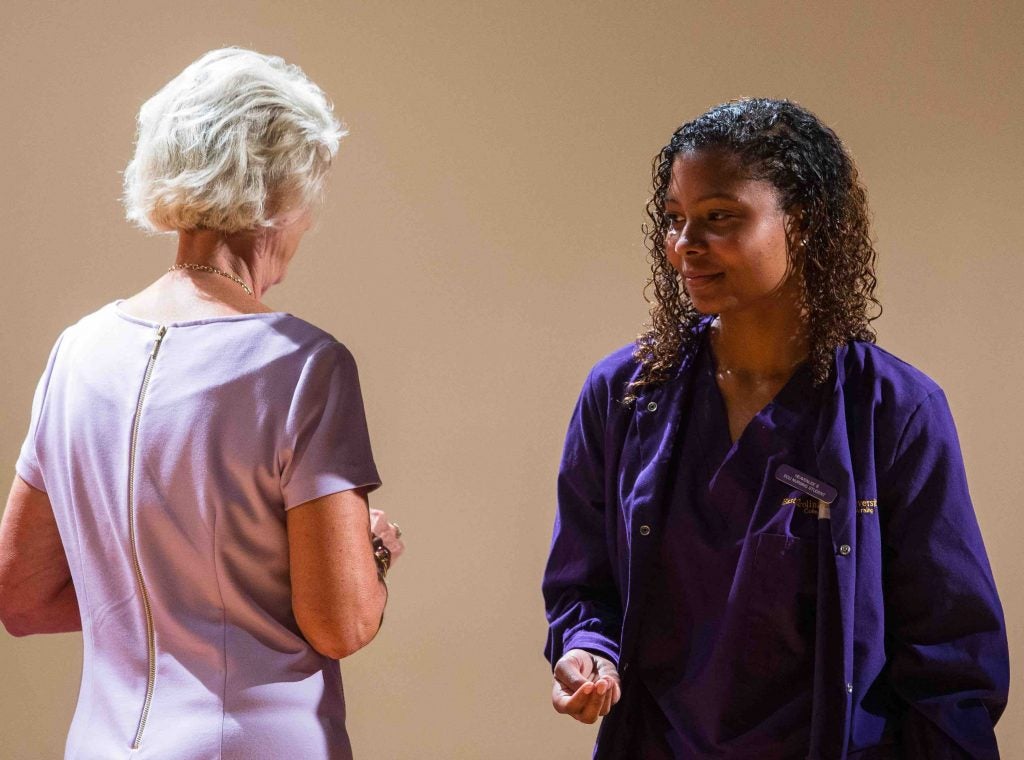 Nursing student Taylor Harrison recites the College of Nursing pledge at the Lamp of Learning ceremony at the Brody School of Medicine on Aug. 31.