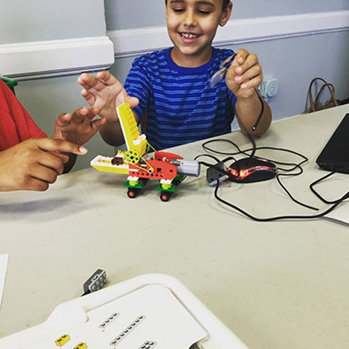 A student admires his successful Lego build using English alumna Megan Oteri’s Brick Scholars concepts. (Contributed photo)