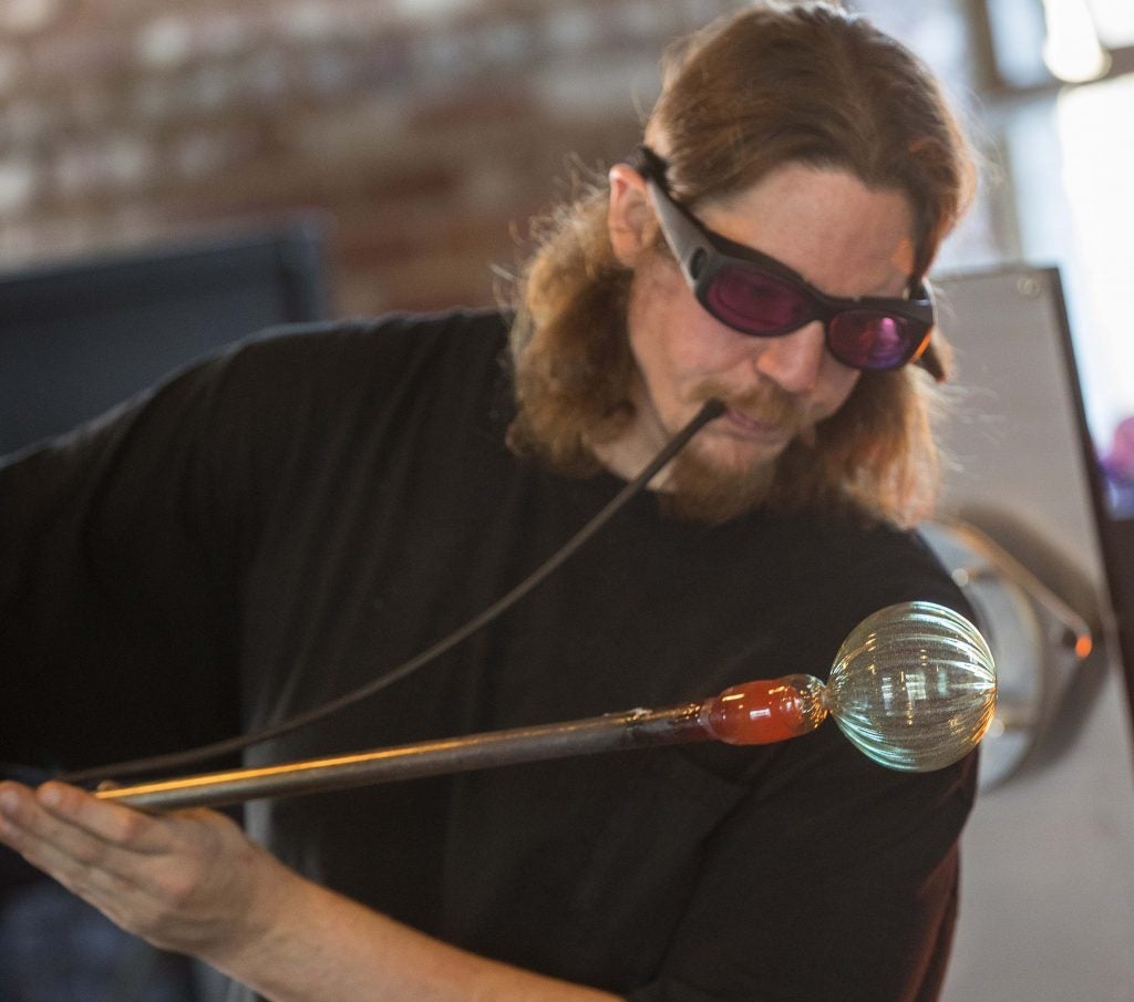 ECU instructor Mike Tracy makes one of 500 ornaments planned for the School of Art and Design’s Hand-blown Holiday Ornament Sale. 