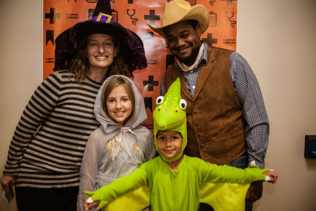 Families pose for photos at the Halloween event.