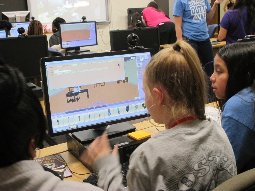 Talijah Barrett, center, collaborates on an application with other MIS STEM camp attendees.