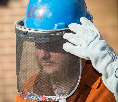 ECU students wearing protective clothing get ready for the annual ECU iron pour