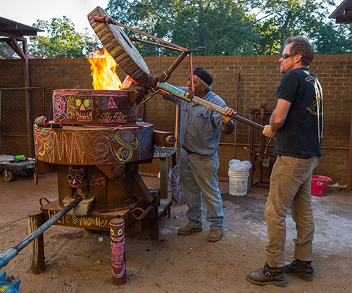 Guest artist Allen Peterson assisted ECU art professor Hanna Jubran before the start of the iron pour.