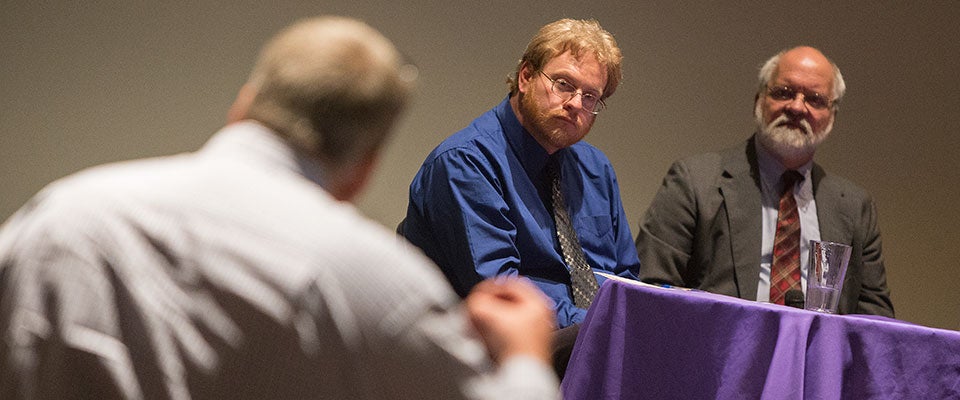 Derek Alderman, head of the Department of Geography at the University of Tennessee, and Gerald Prokopowicz, ECU professor of history, listen to discussion about memorials and building names at the Brewster Forum on Tuesday.