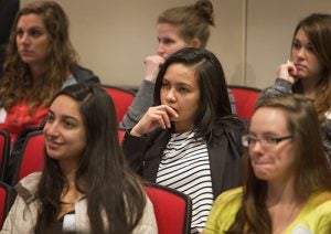 Audience members listen to the keynote speaker at the 12th annual Mills Symposium.