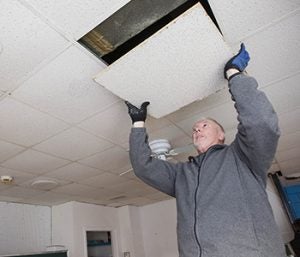 College of Business graduate student Don Philyaw removes tile at the Salvation Army’s Family Store.