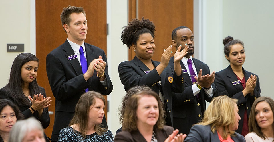 Members of the Elite Pirates applaud Chancellor Steve Ballard as he is recognized by the Board of Trustees.