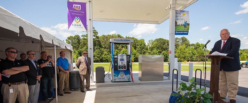 Officials gather at the new CNG fueling station, a stop on the national Sea to Shining Sea Rally, where organizer Pat Riley addressed the crowd. 