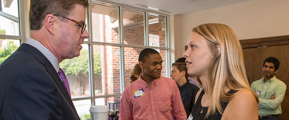  Chancellor-elect Cecil Staton talks with student Charlotte Pearsall at The Croatan on Thursday morning.