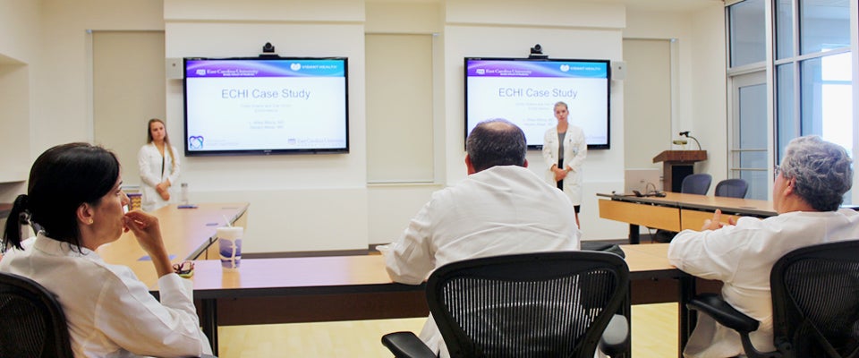 Honors College students and EC Scholars Emily Downs and Zoe Hinton presented a patient case study to conclude their East Carolina Heart Institute internship with ECU’s Robotic Surgery Center for Training and Education.