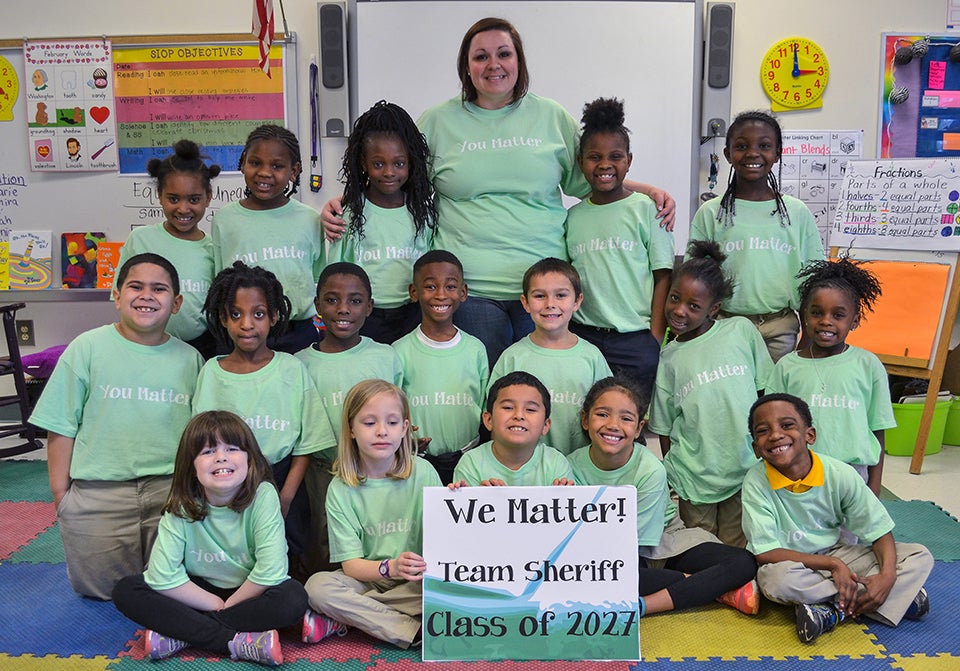 Toni Sheriff ’11 with her first-grade students at Eastern Elementary after they received their You Matter shirts. (Contributed photo)