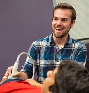 ECU graduate student Jeff Patterson, biomechanics demonstrates an ultrasound machine as part of National Biomechanics Day.