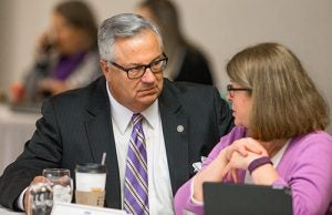 UNC Board of Governors liaison Henry Hinton and ECU Board of Trustees member Deborah Davis review the timeline at the latest Chancellor Search Committee meeting, where it was decided that committee members will begin examining candidate resumes.