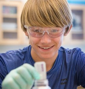 Henry Stecher, 13, of Kill Devil Hills prepares a water sample to be tested for harmful bacteria.