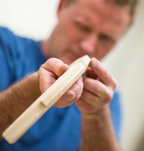 Gerald Weckesser checks the angle of a carved knee.