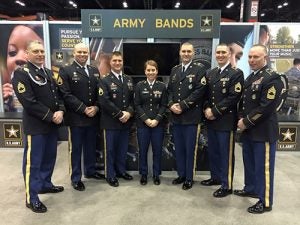 Staff Sergeant Jackie Jones ’06, center, with the Army Music Recruiter Liaison team at Midwest Band and Orchestra Clinic, December 2015. (Photo contributed)