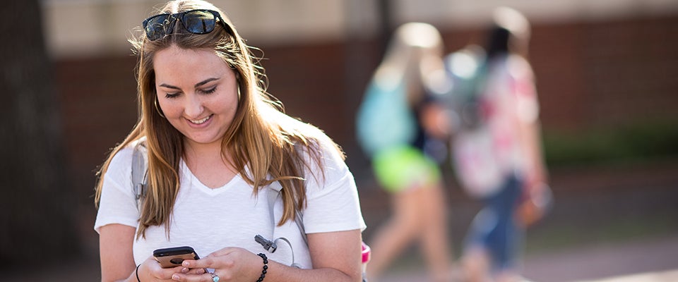 Below: Natalie Leitz, a senior communications major, invites a friend to virtually walk with her using the app’s SafeWalk feature. Using a GPS-enabled map, friends can watch you walk to make sure you arrive at your destination safely.